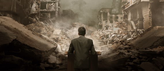 A person in business attire looking at a destroyed city.